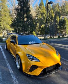 a yellow sports car parked in a parking lot