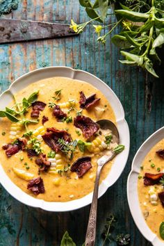 two white bowls filled with soup and garnished with bacon