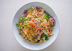 a white bowl filled with salad on top of a table