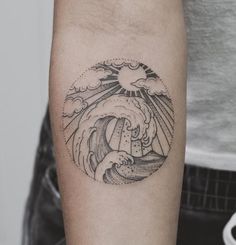 a person with a tattoo on their arm that has a wave coming out of it