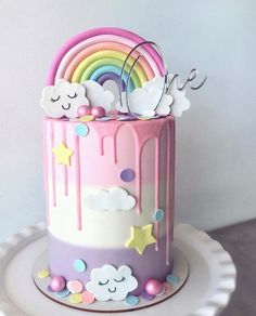 there is a cake decorated with rainbows and clouds