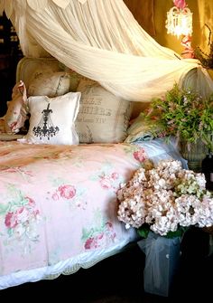 a bed with pink and white flowers on it