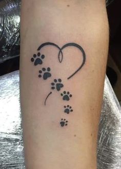 a dog paw print in the shape of a heart with an animal's paw prints on it