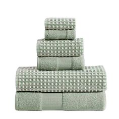 four towels stacked on top of each other in green and white checkered patterning