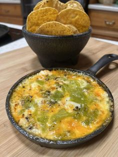 an omelet with tortilla chips in a bowl on a counter top