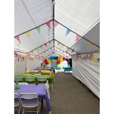 tables and chairs are set up in a large tent for an event or birthday party