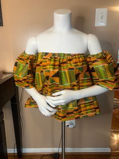 Gorgeous kente Off Shoulder Top is perfect  Perfect for all occasions.  Top has a comfortable elastic band at bust line and arm Pair it up with shorts, pants or skirts while turning heads Size- Small, Medium & Large Ankara Off Shoulder Top, Ankara Midi Skirt, Casual Christmas Outfits, Ankara Blouse, Christmas Outfit Casual, Kente Dress, African Tops, Cute Christmas Outfits, African Print Skirt