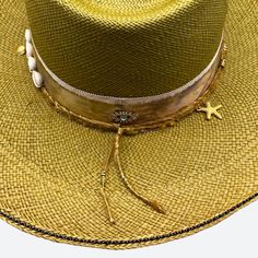 Silk and cotton ribbons with small details around crown Sweatband with 'Sun, Sea & Sand' inspirational quote All hats are unique and have perfect imperfections! Straw hat hand woven in Ecuador Hand made and designed by Valeria in California Gold Wide Brim Fedora For Festivals, Luxury Flat Brim Straw Hat For Summer, Luxury Short Brim Panama Hat For Summer, Gold Fedora Straw Hat For Kentucky Derby, Gold Fedora With Short Brim For Festivals, Luxury Panama Hat For Summer Beach, Luxury Toquilla Straw Panama Hat For Summer, Luxury Panama Hat For Vacation, Luxury Brimmed Straw Hat For Summer