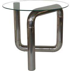 a round glass table with metal legs