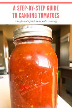 a mason jar filled with tomato sauce sitting on top of a counter