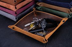 several pairs of scissors and keys in a leather case