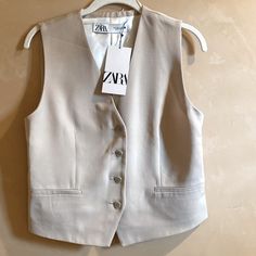 Zara Light Tan Vest / Waistcoat - Size S - A Relaxed Feel On New With Tags Sleeveless Vest/Top Is Lined And Has Buttons Up The Front. 2 (False) Front Pockets And A Back Vent. Approx. Measurements Laid Flat: Underarm To Underarm: 17.5” Length Center Back To Hem: 18.5” Exterior 62% Viscose 38% Lyocell Lining 100% Viscose Excellent Condition, Never Worn. Item Bought In Switzerland. Cover Photo Is A Stock Photo Not Item For Sale. Classic Zara Summer Outerwear, Zara Classic Summer Outerwear, Tailored Spring Vest Outerwear, Beige Single Breasted Vest For Spring, Spring Single Breasted Vest In Beige, Spring Office Vest Single Breasted, Beige Single-breasted Vest For Spring, Spring Single-breasted Office Vest, Spring Beige Single Breasted Vest