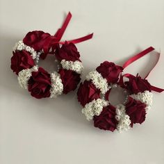 two red and white flowers are tied together