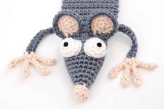 a crocheted mouse hat with googly eyes