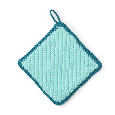 a crocheted dishcloth with a blue square on the front and green squares on the back