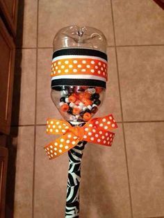 a candy filled lollipop with orange and black polka dots