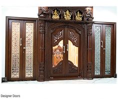 an ornately carved wooden door with glass panels on the front and side doors to both sides