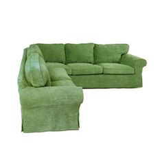 a green couch and footstool sitting next to each other on a white background