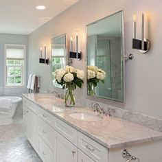 a large bathroom with two sinks and a tub