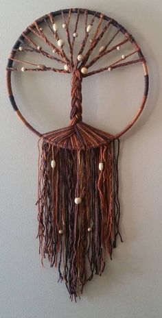 a decorative wall hanging made out of wood and wire with beads on it's sides