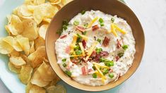 a bowl of dip and chips on a plate