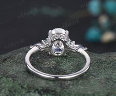 an engagement ring on top of a rock