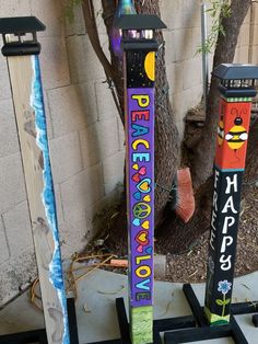 two colorful skis are standing next to each other in front of a tree and fence