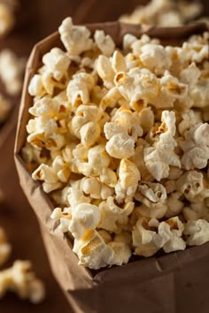 a brown paper bag filled with popcorn on top of a table