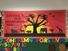 a bulletin board with animals and trees on it in front of the words letting our imaginations run wild