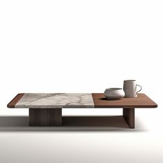 a coffee table with two cups on it and a white wall in the back ground