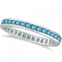 a white gold ring with blue topazs and channel set diamonds on the side