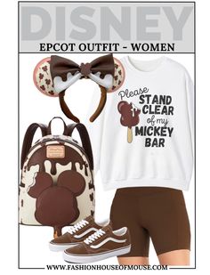 a woman in brown shorts and white shirt with mickey mouse ears on her head is wearing a