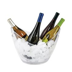 several bottles of wine are in a glass bowl filled with ice cubes on a white background