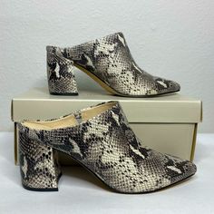 Marc Fisher Fragni Snakeskin Embossed Mule, Size 7.5. Cream, Grey, And Black Python Print Faux Leather. Brand New In Box. The Pointed Toe Fragni Mule Is Designed With A Contemporary Snakeskin Embossed Silhouette That's Sure To Bring A Glam Vibe To Any Outfit. Sizing: True To Size. M=Standard Width - Pointed Toe - Covered Vamp - Snakeskin Embossed Upper - Slip-On - Lightly Cushioned Footbed - Mule Back - Covered Block Heel - Approx. 3" Heel Fall Heels With Textured Sole And Pointed Toe, Fall Heels With Textured Sole And Closed Toe, Spring Snake Print Pointed Toe Heels, Gray Block Heel Heels, Snake Print Pointed Toe Heels Medium Width, Snake Print Heels With Pointed Toe, Chic Gray Block Heel Shoes, Gray Closed Toe Heels For Fall, Gray Medium Width Heels For Spring