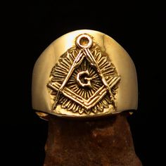 This stunning Master Mason Blue Lodge Ring in gold shiny brass is crafted from solid brass and measures 19 mm along the finger. It exudes elegance and sophistication, making it the perfect accessory for any masonic member. We ship worldwide to 185 countries! Please allow 1-2 business weeks for your order to arrive. Classic Adjustable Gold Signet Ring, Adjustable Gold Brass Signet Ring, Adjustable Yellow Gold Brass Signet Ring, Adjustable Gold Engraved Signet Ring, Symbolic Brass Rings For Formal Occasions, Antique Engraved Gold Brass Ring, Antique Brass Engraved Gold Ring, Ceremonial Adjustable Gold Engraved Ring, Gold Brass Signet Ring With Symbolic Style