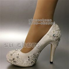 a woman's white high heeled shoes with flowers