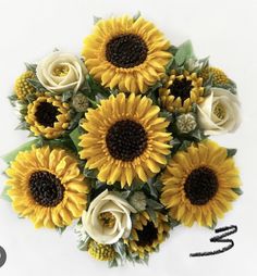 a bouquet of sunflowers and roses on a white background