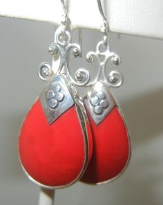 "Sterling silver and coral earrings. Beautiful, deep red, sponge coral set in a thick teardrop bezel. The pointed cap has four pebbles and the top that connects to the ear wire, has a swirl design, with tiny pebble balls at the end. The ear wires have two tiny granulation pebbles, above the loop. Stunning earrings, solid but not too heavy. The back is open and has a border around the coral. Handmade in Bali. Please see detailed measurements below. > Earrings weigh 6.6 grams. > Sterling sil Red Nickel-free Teardrop Earrings, Nickel-free Red Teardrop Earrings, Nickel Free Red Teardrop Earrings, Red Teardrop Sterling Silver Jewelry, Silver Braided Ring, Earrings Bali, Bali Jewelry, Sponge Coral, Petite Ring