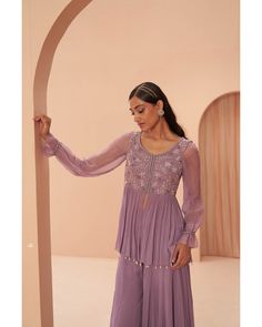 Lilac Breeze Sharara Set - Parul Gandhi Elevate your style with a beautiful peplum sharara set featuring delicate floral embroidery adorning the torso. This ensemble exudes sophistication, combining the trendy peplum silhouette with intricate floral details for a perfect balance of elegance and modern flair. Included in Purchase: Sharara Top, Pant & Dupatta Product Specification Color: Lavender Fabric: Georgette Neckline: Scoop Occasion: Bridal, Engagement, Formal Event Designer: Parul Gandhi Wo Purple Georgette Blouse For Eid, Lavender Sharara, Peplum Sharara, Kurta And Sharara Set, Kurta And Sharara, Indian Wedding Bride, Add Sleeves, Indian Bridal Lehenga, Embroidered Bodice