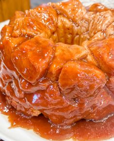 a bundt cake covered in caramel glaze on a white plate with a fork