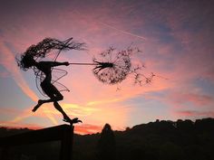 a woman is flying through the air with a dandelion in front of her