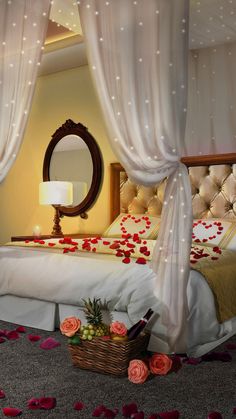 a bed with rose petals on it and a mirror