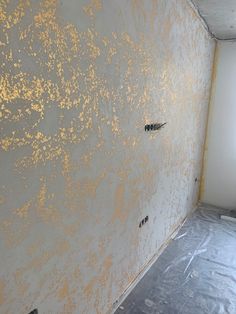 an unfinished room with yellow paint on the wall and flooring covering it's walls