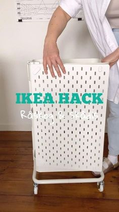 a woman standing next to a white radiator on top of a hard wood floor