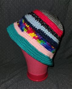 a multicolored crocheted hat sitting on top of a head