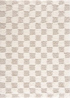 an area rug with squares on it in beige and white colors, made from thick wool