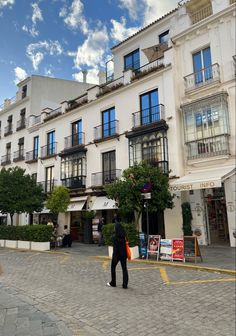 a person is walking in front of some buildings