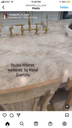 a marble counter top with gold faucets and two sinks in the middle is shown