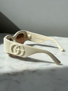 Brand new Gucci GG1544S 004 Ivory White Thick Rim Sunglasses. Oversized shiny white logos on temples.100% UVA/UVB protected. Dark brown lens.Size 53-21-140.Comes with Gucci jewel toned case, cloth, satin pouch, and authenticity card.100% authentic. Made in Italy. Retail price $380. Gucci Luxury Tinted Sunglasses, Chic Gucci Yellow Sunglasses, Vintage Gucci Sunglasses, Gucci Outfit, Satin Pouch, Sunglasses Oversized, Brown Lens, Men's Eyeglasses, Gucci Sunglasses