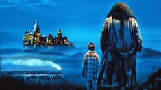 there is a man standing next to a woman in front of hog potter's castle